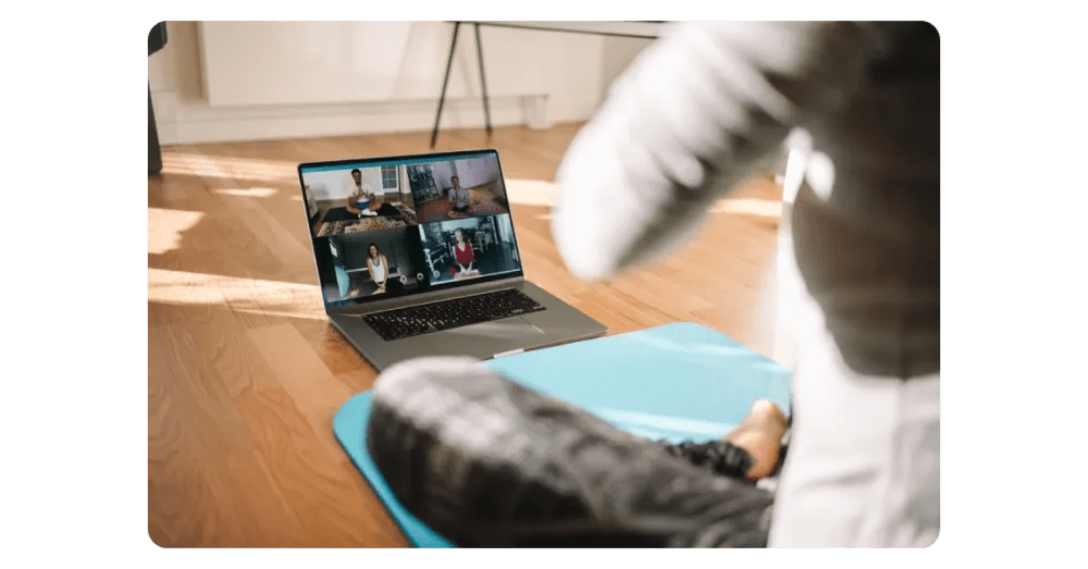 Employee attending an online yoga class as part of a distributed wellness program