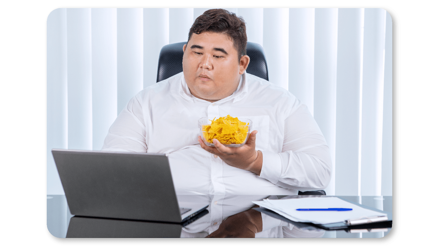Obese employee eating junk at work
