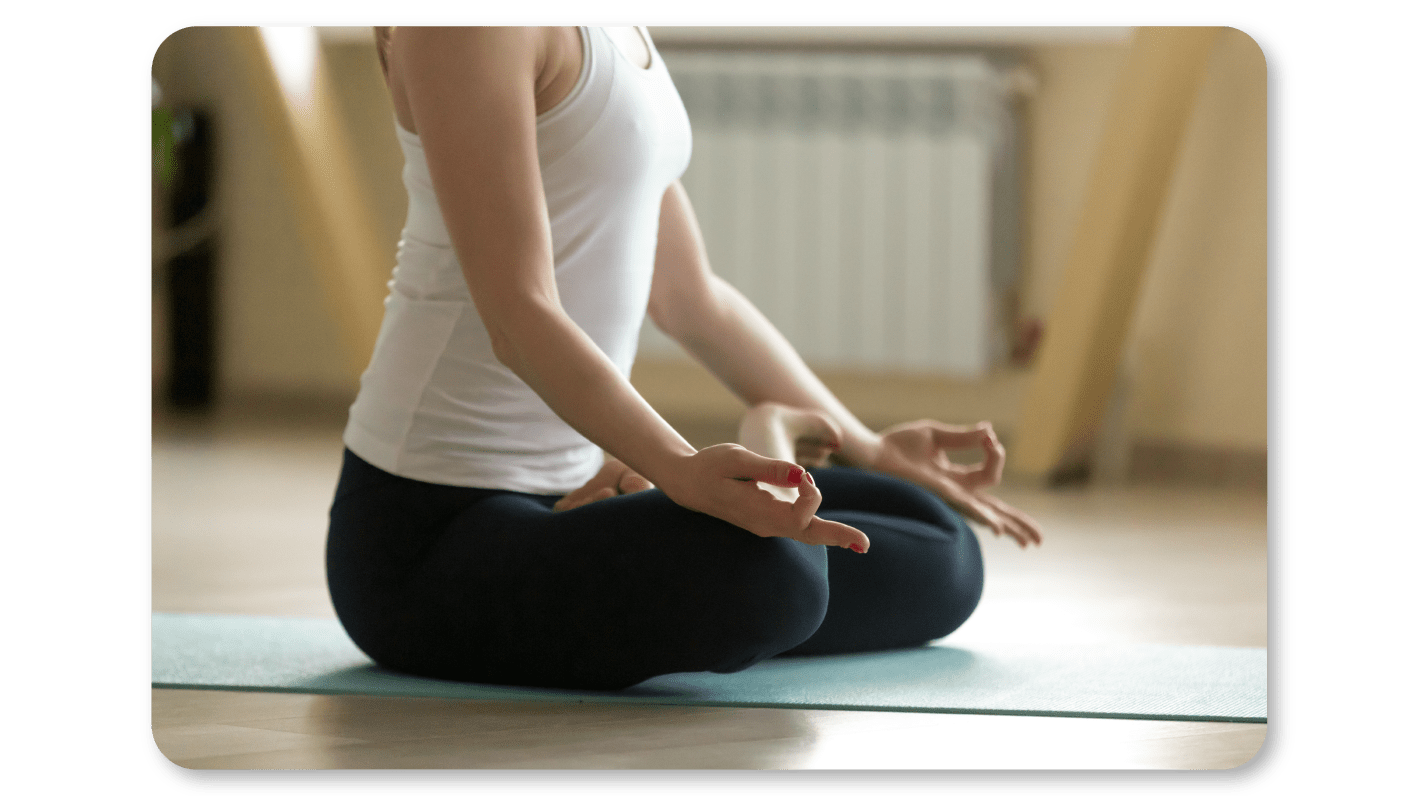 An Employee Practices Self Care At Work by Practicing Meditation