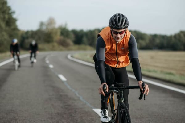 Employee cycling on an open road