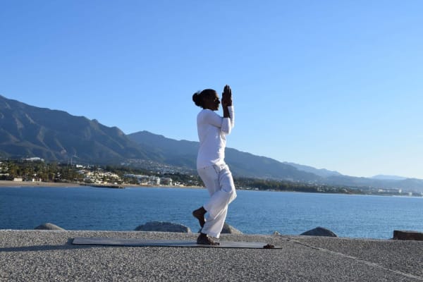 Employee meditating outdoors by the sea