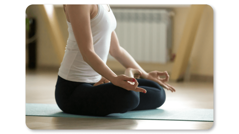An Employee Practices Self Care At Work by Practicing Meditation