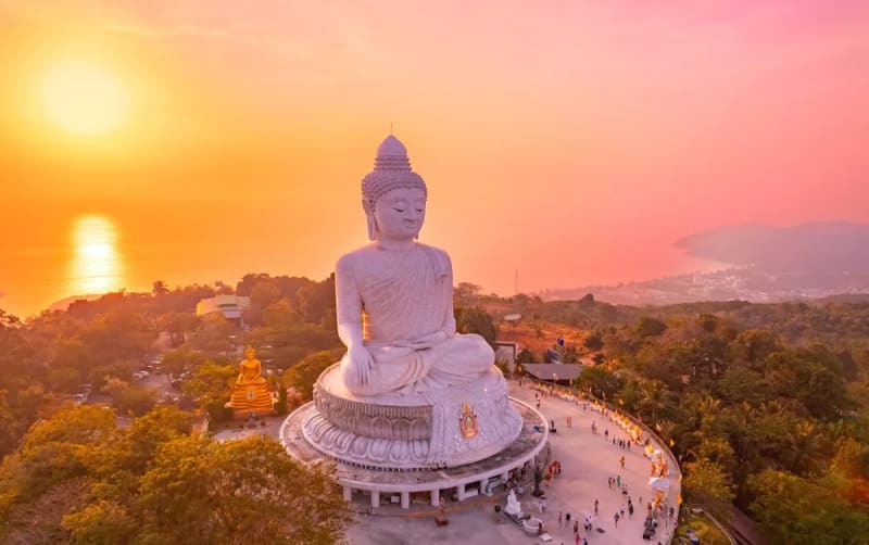 Aerial view of the Big Buddha statue in Phuket, Thailand at sunset , venue destination for the 20th anniversary Global Wellness Summit, November 10-13, 2026