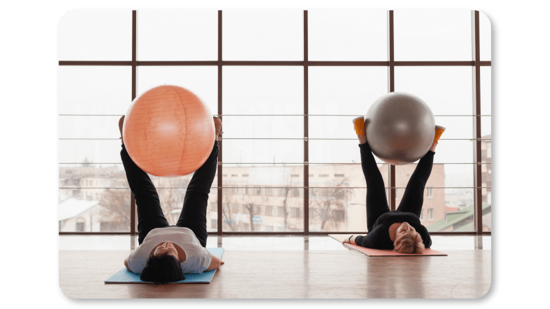 two-women-pilates-with-ball