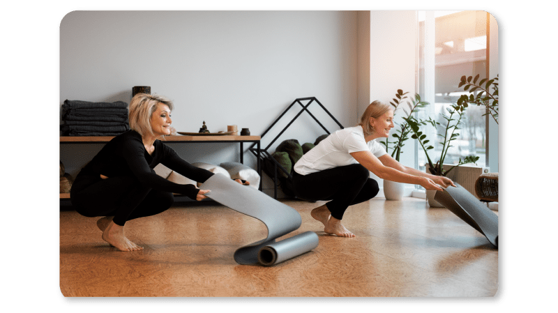 two-women-unrolling-mats