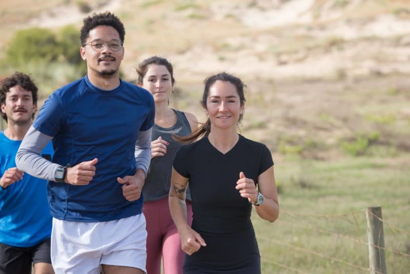 Group of employees running together outdoors